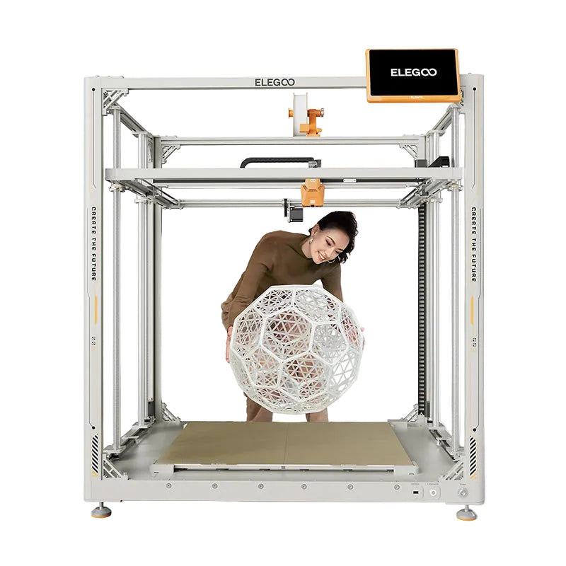 Person standing inside the ELEGOO OrangeStorm Giga build chamber holding a large 3D printed spherical model to demonstrate scale.