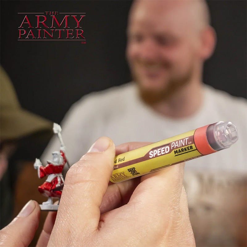 Hobbyist applying detail to a miniature with a Speedpaint Marker